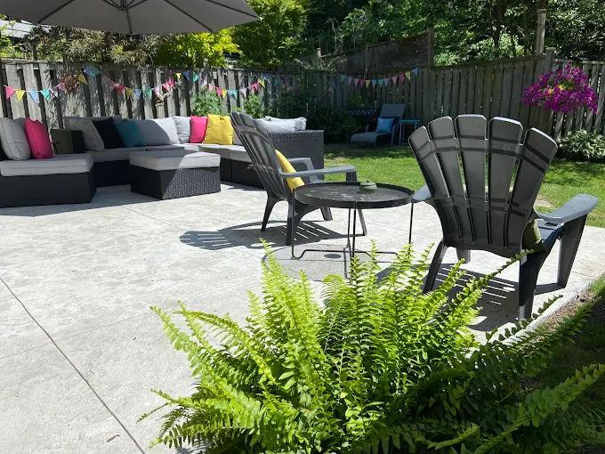 Concrete patio with stone accents and seating wall