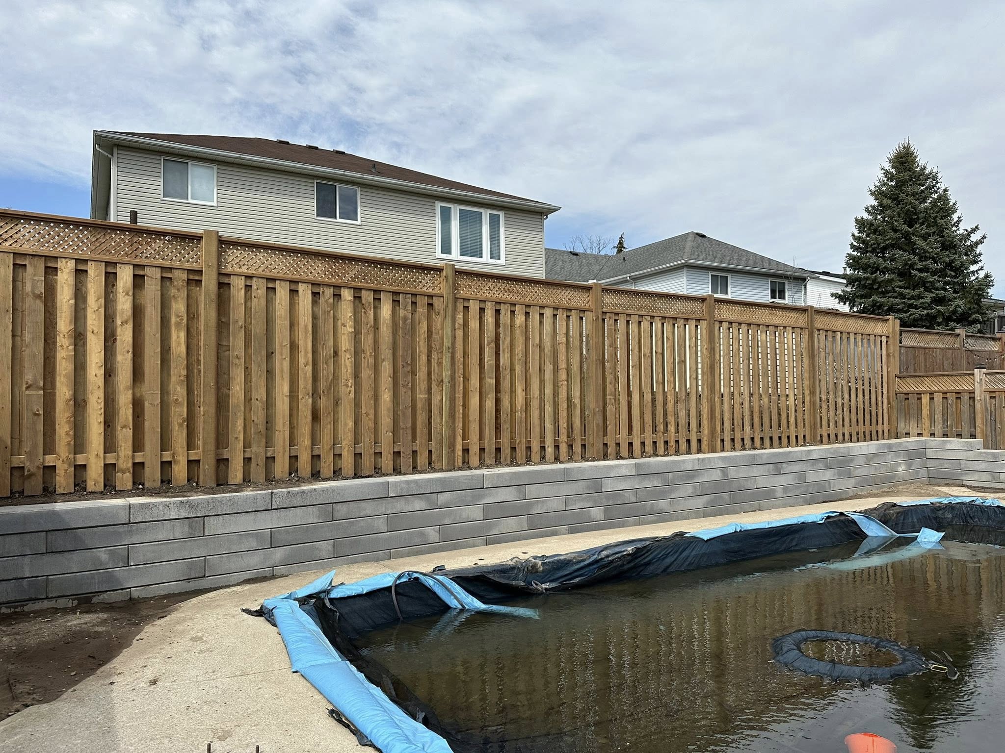 400LB block retaining wall and new fence, strength and style in one project.